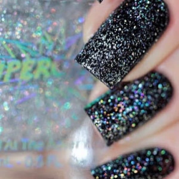 Scattered holographic nail polish by superchic lacquer in white rainbow shown on womans hands